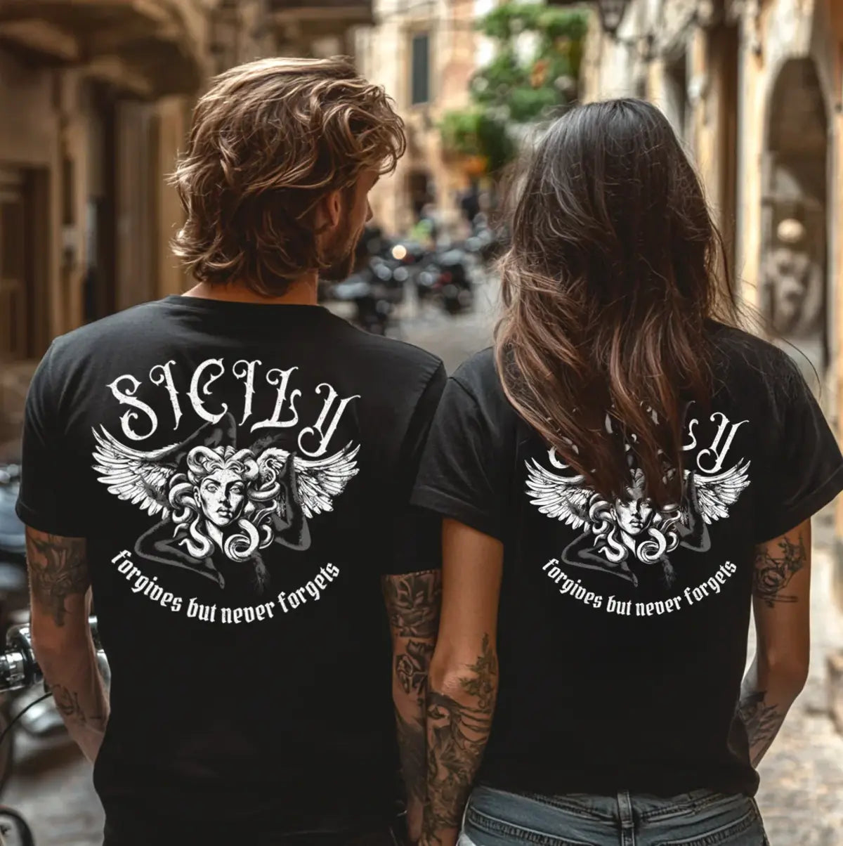 Two people wearing black t-shirts with gothic tattoo Sicily design Sicily forgives but never forgets with Trinacria symbol - Sicilian pride apparel gift .