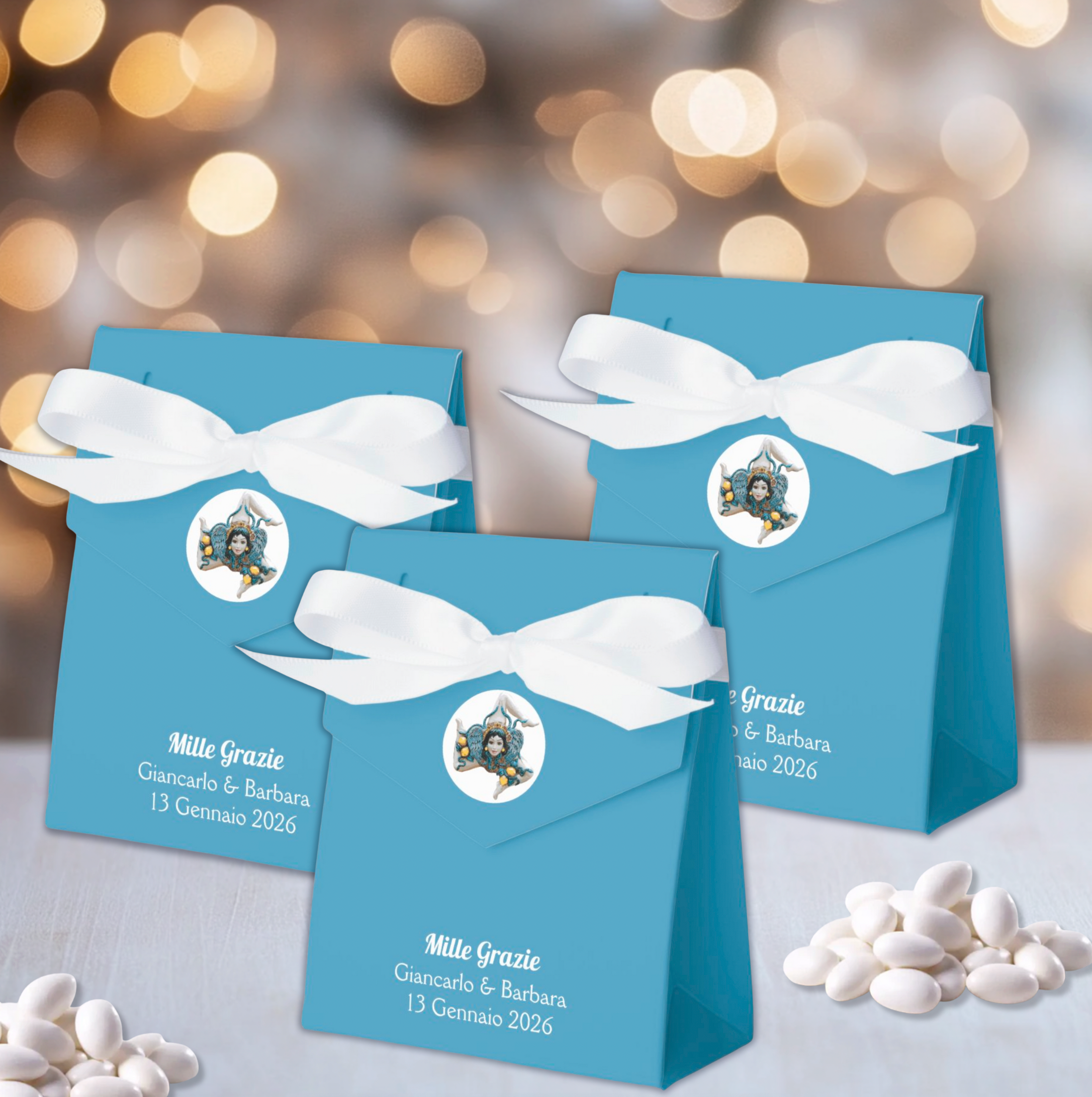 Personalized blue tent favor box featuring Trinacria in white circle closure and white satin ribbon, customizable with "Grazie," names, and event date. Sicilian heritage party favors, wedding thank you boxes, baptism favors, communion favors, anniversary celebration favors, Italian event favors.