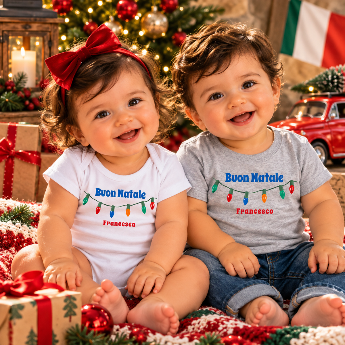 Two adorable babies wearing personalized “Buon Natale” Christmas outfits—a white bodysuit and gray T-shirt with colorful holiday lights. Perfect Italian Christmas gifts.