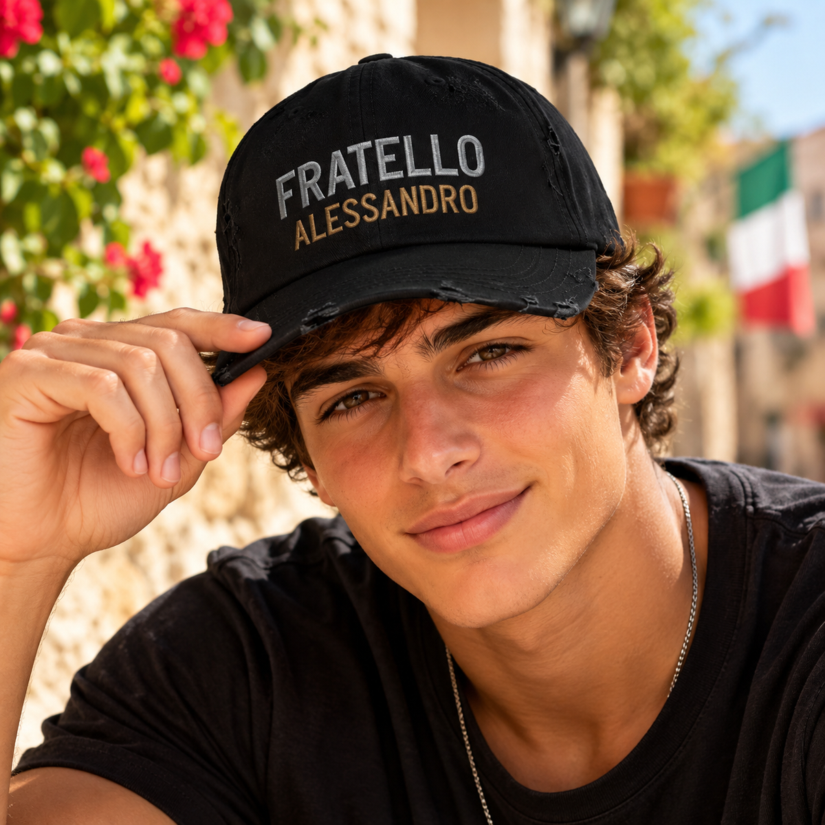 Young Italian man wearing personalized black Fratello (Brother) baseball cap with Alessandro name embroidery. Italian heritage gift.