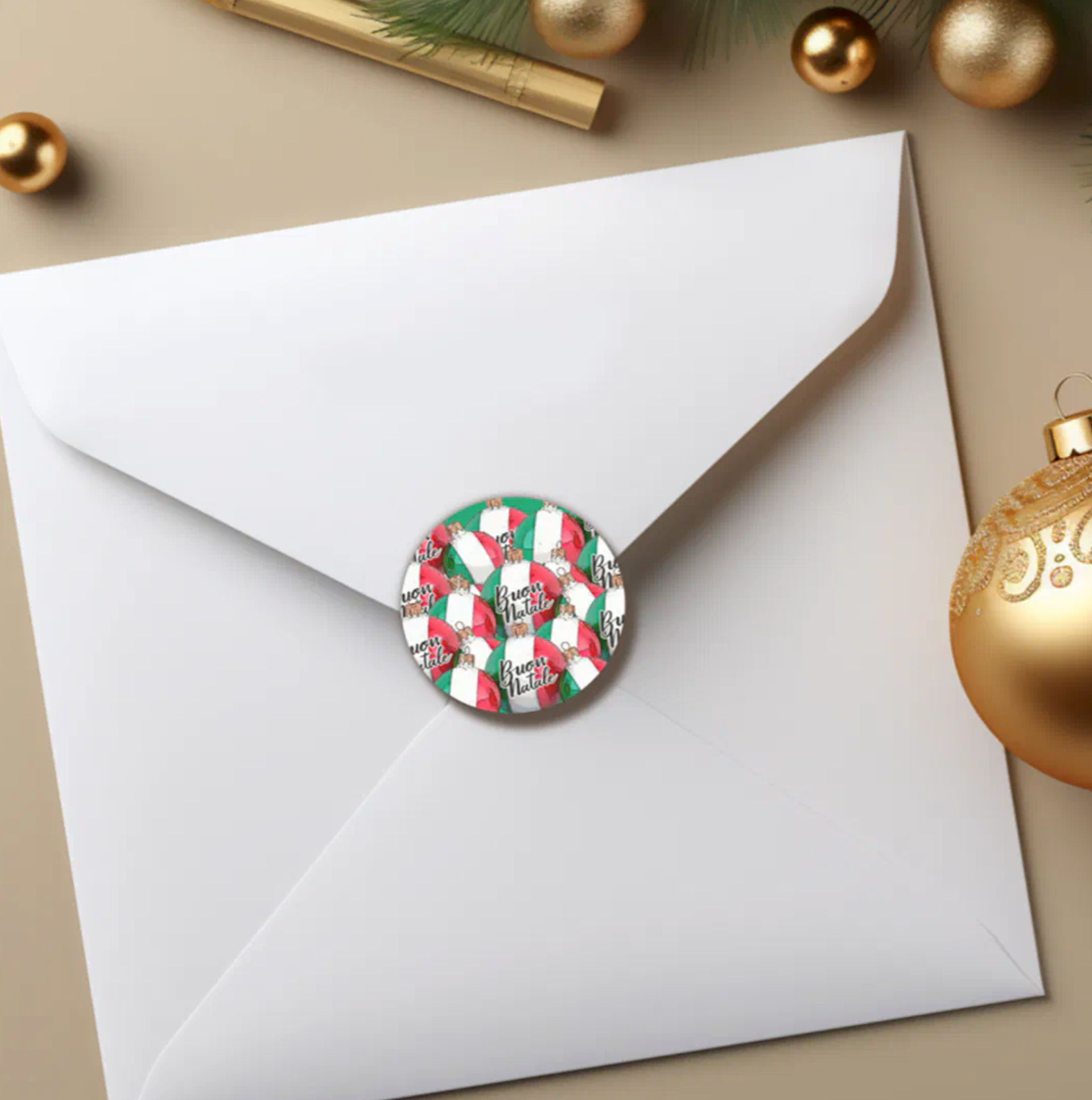 White envelope with a decorative sticker and Christmas ornaments on a beige surface
