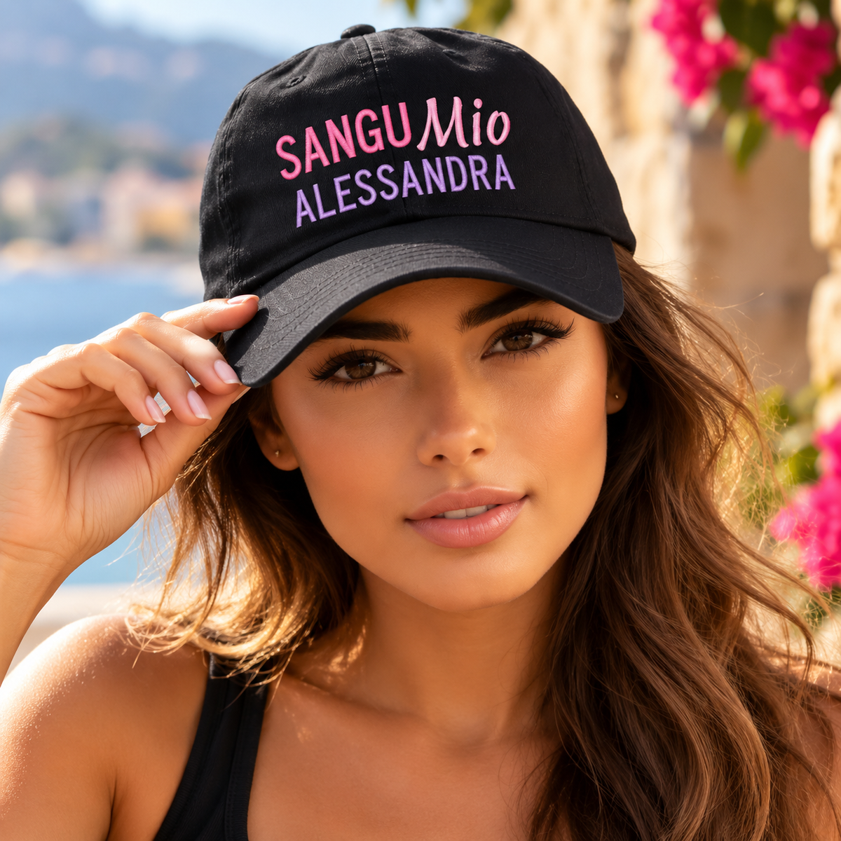 Italian beauty with attitude wearing a personalized black Sangu Mio Alessandra embroidered cap in pink and lavender. Bold Sicilian family pride!