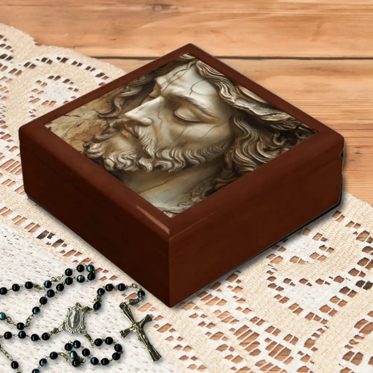 Wooden keepsake box with classical religious Jesus sculpture design on a lace tablecloth.
