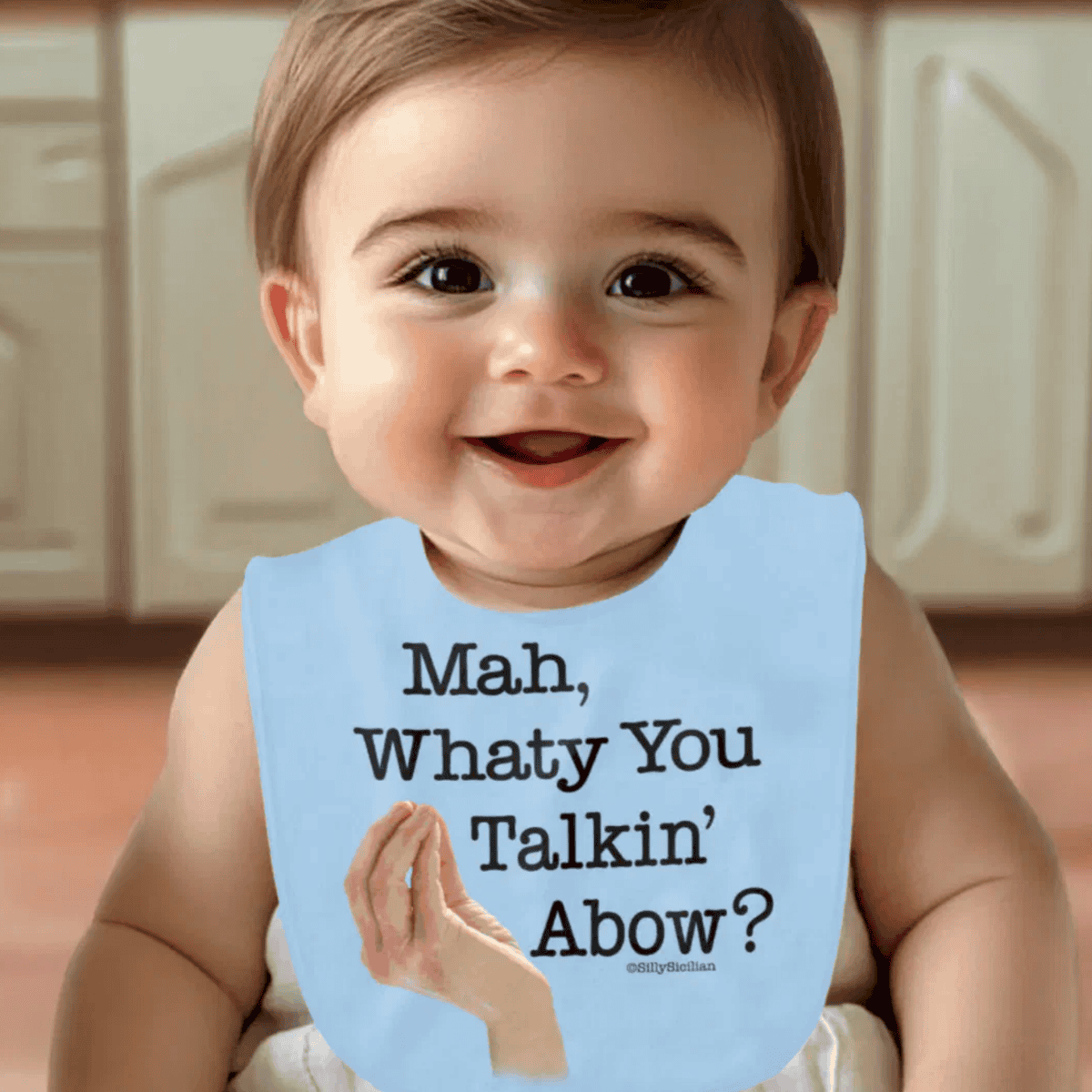 Baby wearing a blue bib with funny Italian-American saying "Mah, whaty you talkin' abow?" - heritage gift for baby