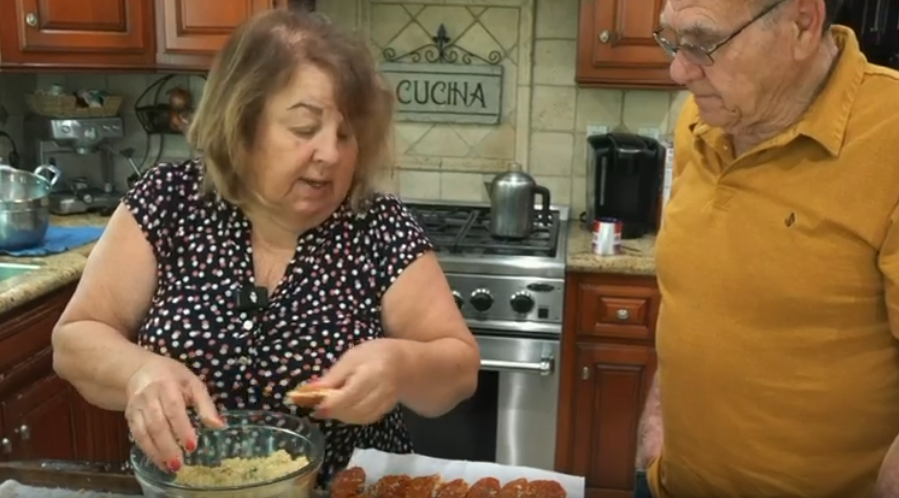 Lia and Mimmo, a real Sicilian couple living in America, laughing together — the stars of The Sicilian Life Unfiltered video series