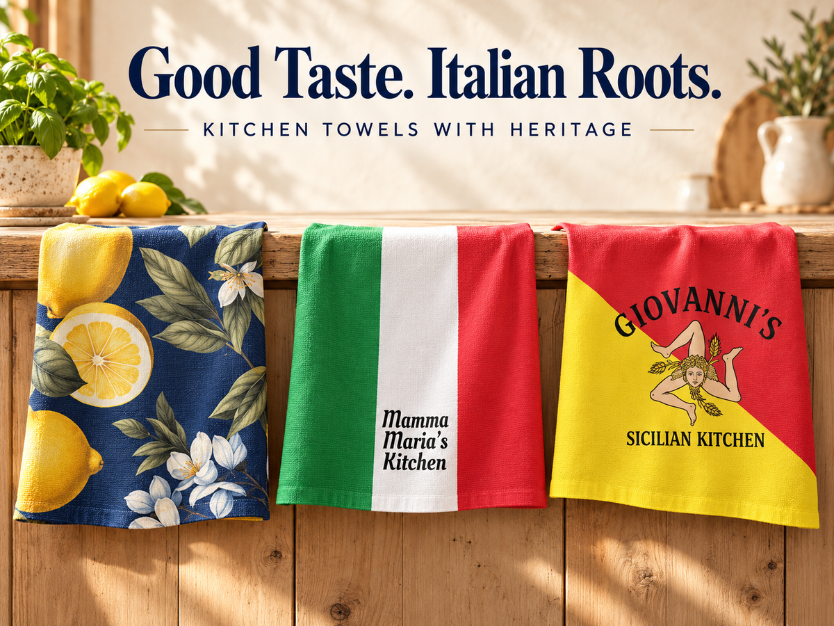 Italian and Sicilian kitchen towels featuring navy lemon print, personalized Italian tricolor and Sicilian flag designs, draped over a wooden kitchen counter.