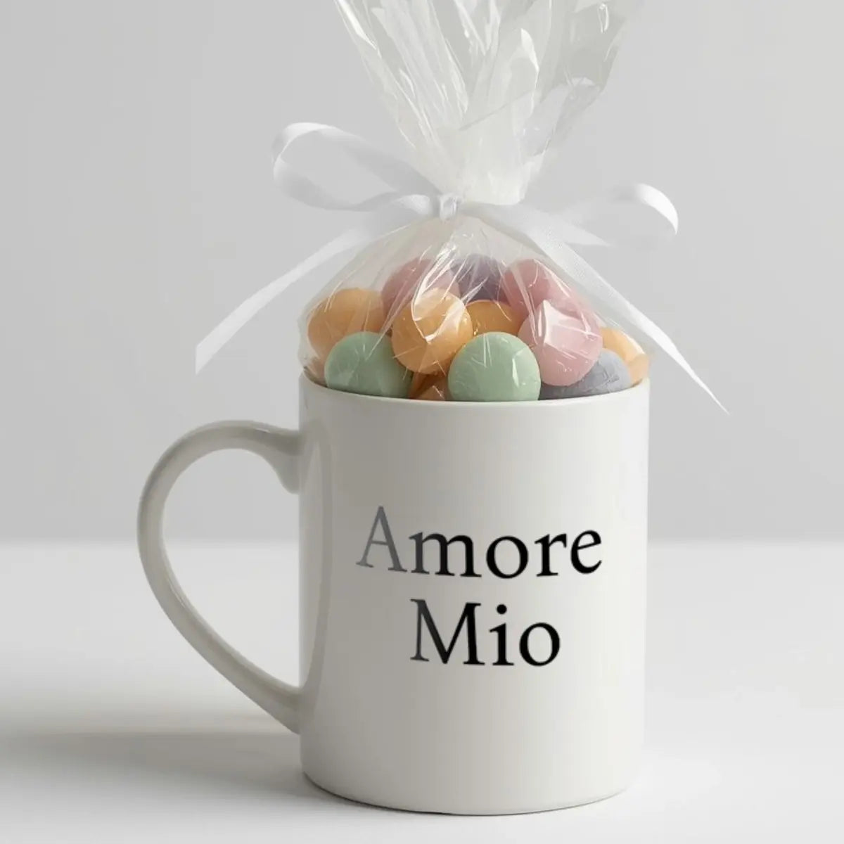Amore Mio (my love) minimalist black serif font on white mug with cellophane and candies tied with white satin bow, keepsake favor. Italian and Sicilian heritage favor, baby shower favor idea, wedding shower favor idea, bridal shower favor, Italian party favor, Italian wedding favor, gift for guests, Italian celebration favor.
