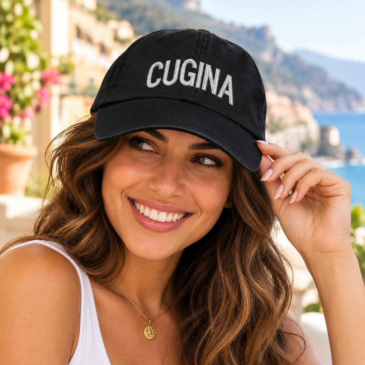 Smiling young Italian woman wearing a black Cugina embroidered baseball cap with white lettering. Italian cousin hat, Sicilian heritage gift, famiglia fashion.