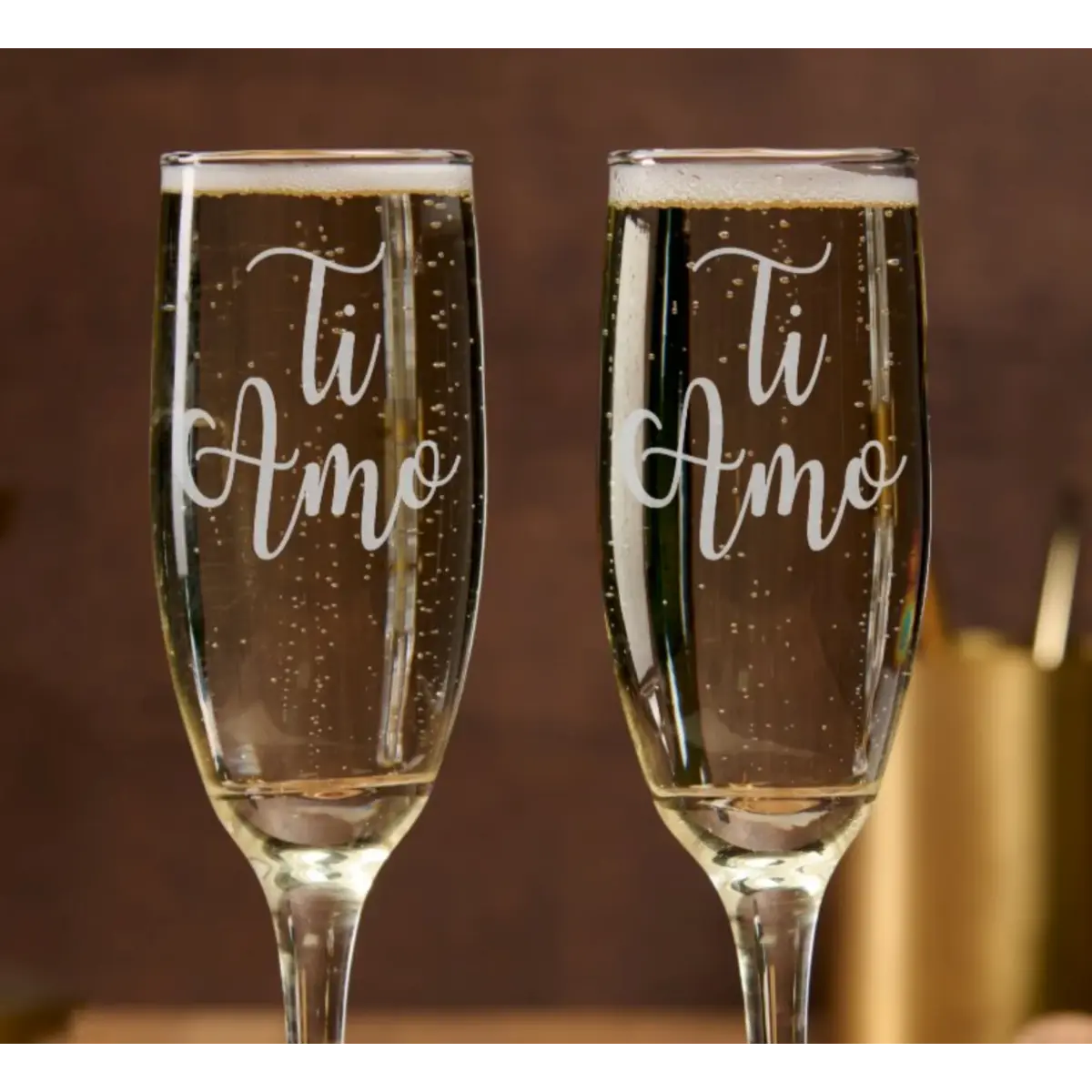 Two champagne flutes with 'Ti Amo' text on a blurred background