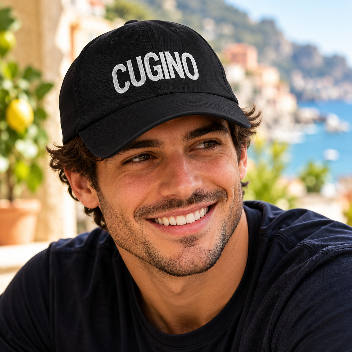Handsome young Italian man wearing a black Cugino embroidered baseball cap with white lettering. Italian cousin hat, Italian heritage gift, famiglia fashion.