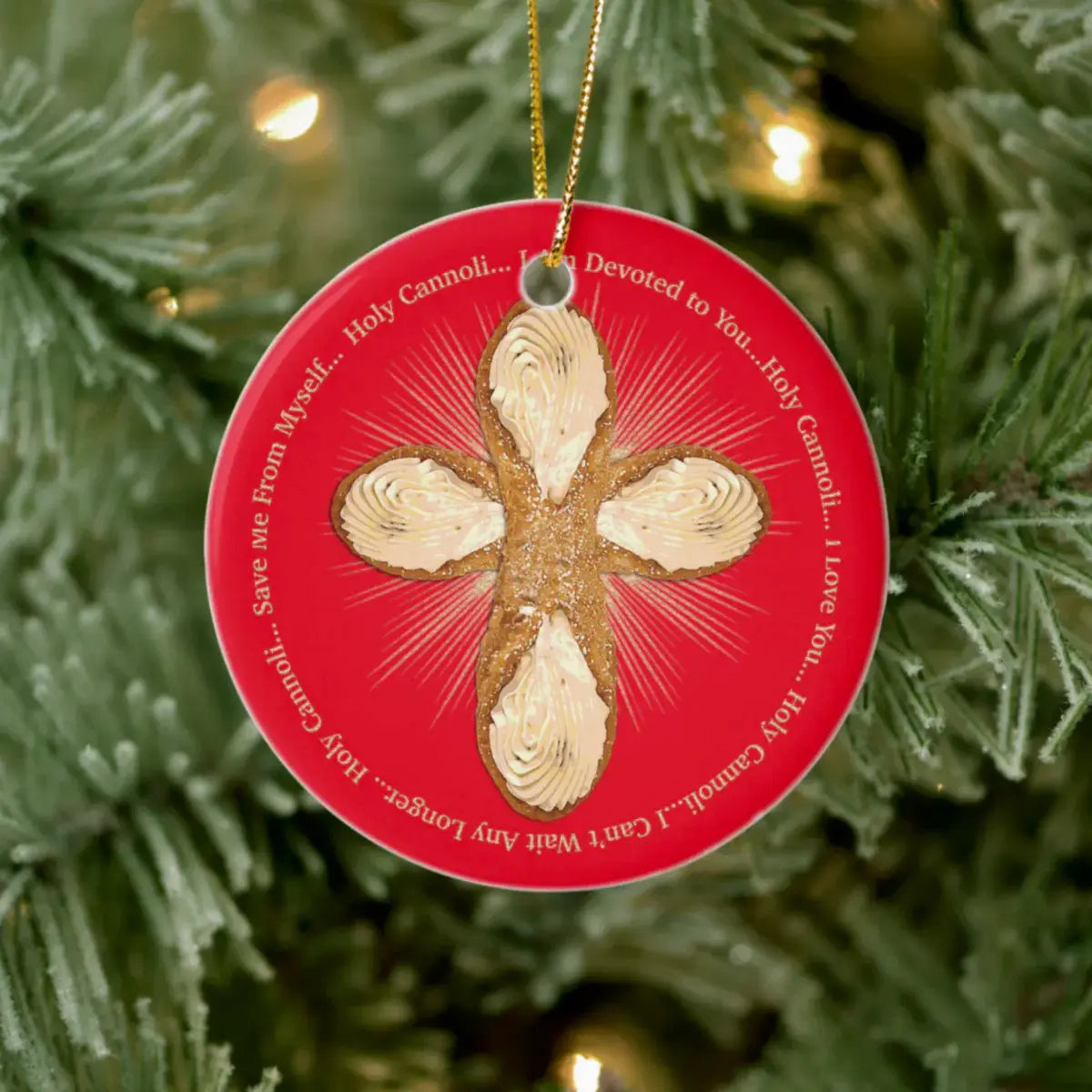 Decorative Christmas ornament with a Holy Cannoli cross design on a red background, hanging on a tree.