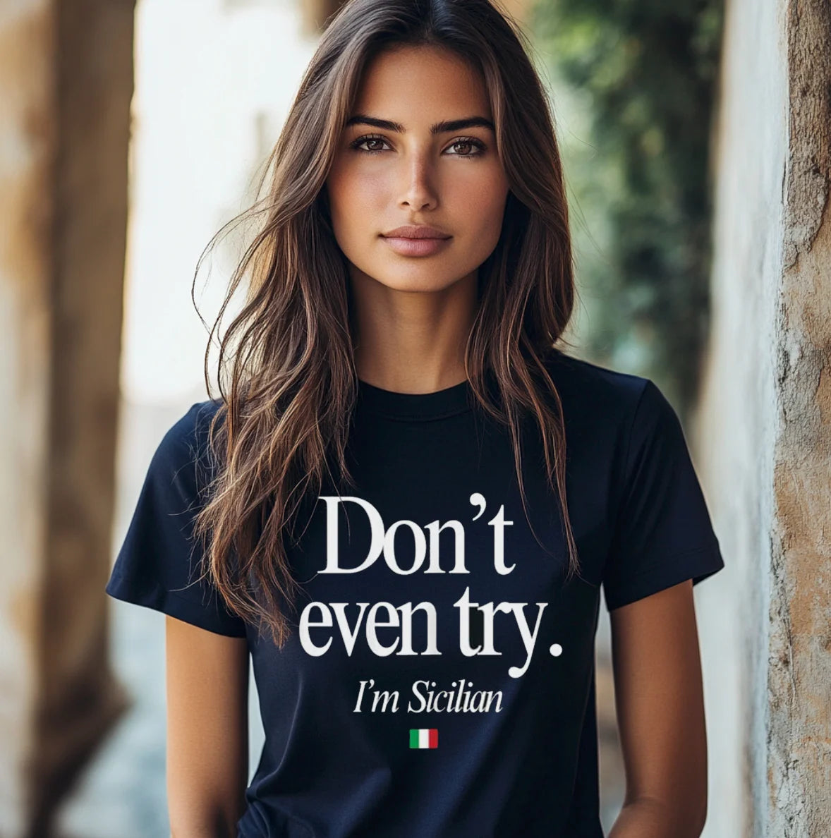 Woman wearing a black t-shirt with 'Don't even try. I'm Sicilian' text and Italian flag.