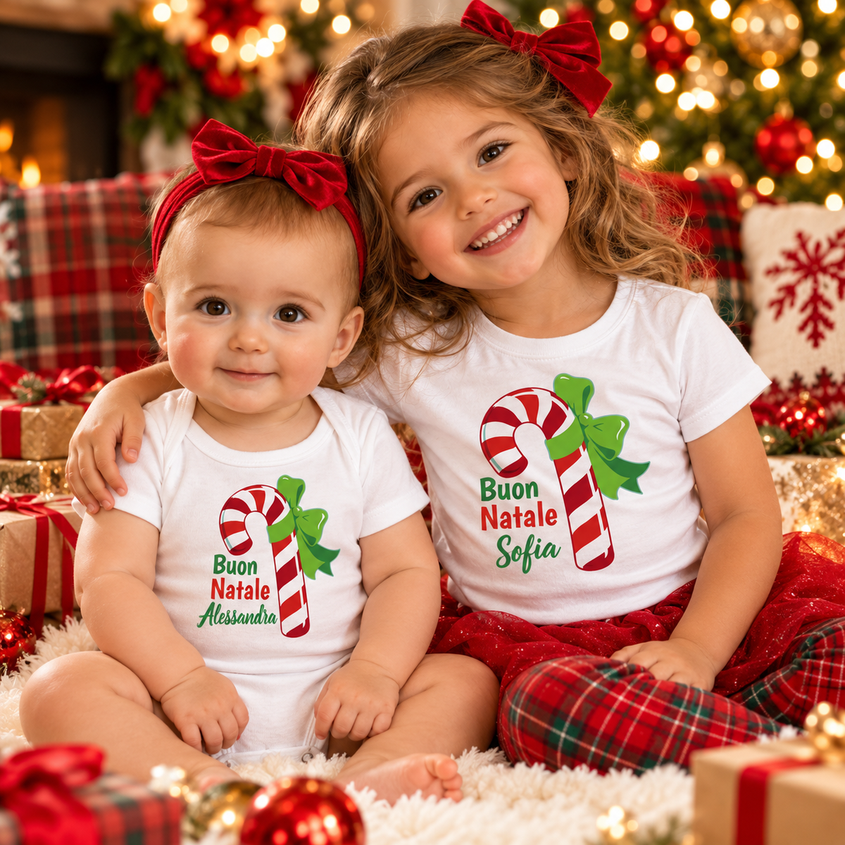 Two sisters in personalized Buon Natale Italian Christmas baby bodysuit and kids' tee with candy canes.