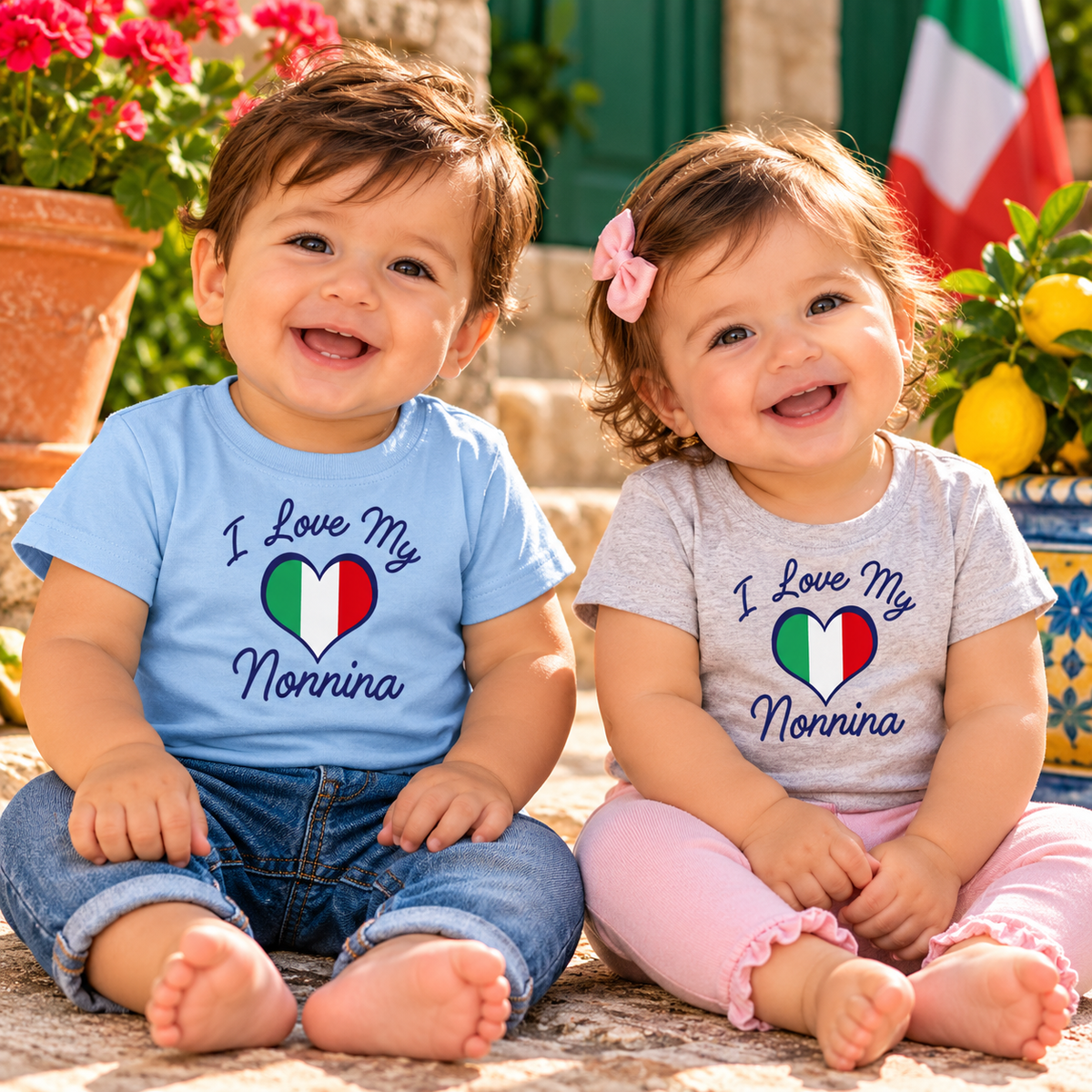 Smiling baby boy and girl in blue and gray “I Love My Nonnina” Italian heritage tees with Italian flag hearts. Sweet gifts for Italian grandmothers.