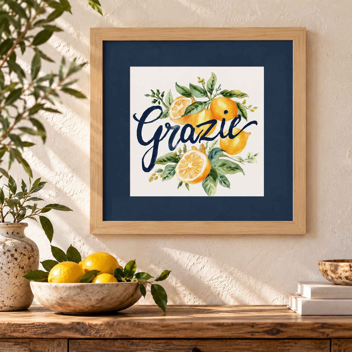 Add Italian elegance to your home with this beautiful “Grazie” framed wall art, meaning “Thank You” in Italian! Featuring delicate watercolor lemons, botanical greenery, elegant navy lettering, a coordinating navy mat and natural wood frame, this Mediterranean-inspired artwork brightens kitchens, dining rooms and entryways. A lovely Italian housewarming or appreciation gift!