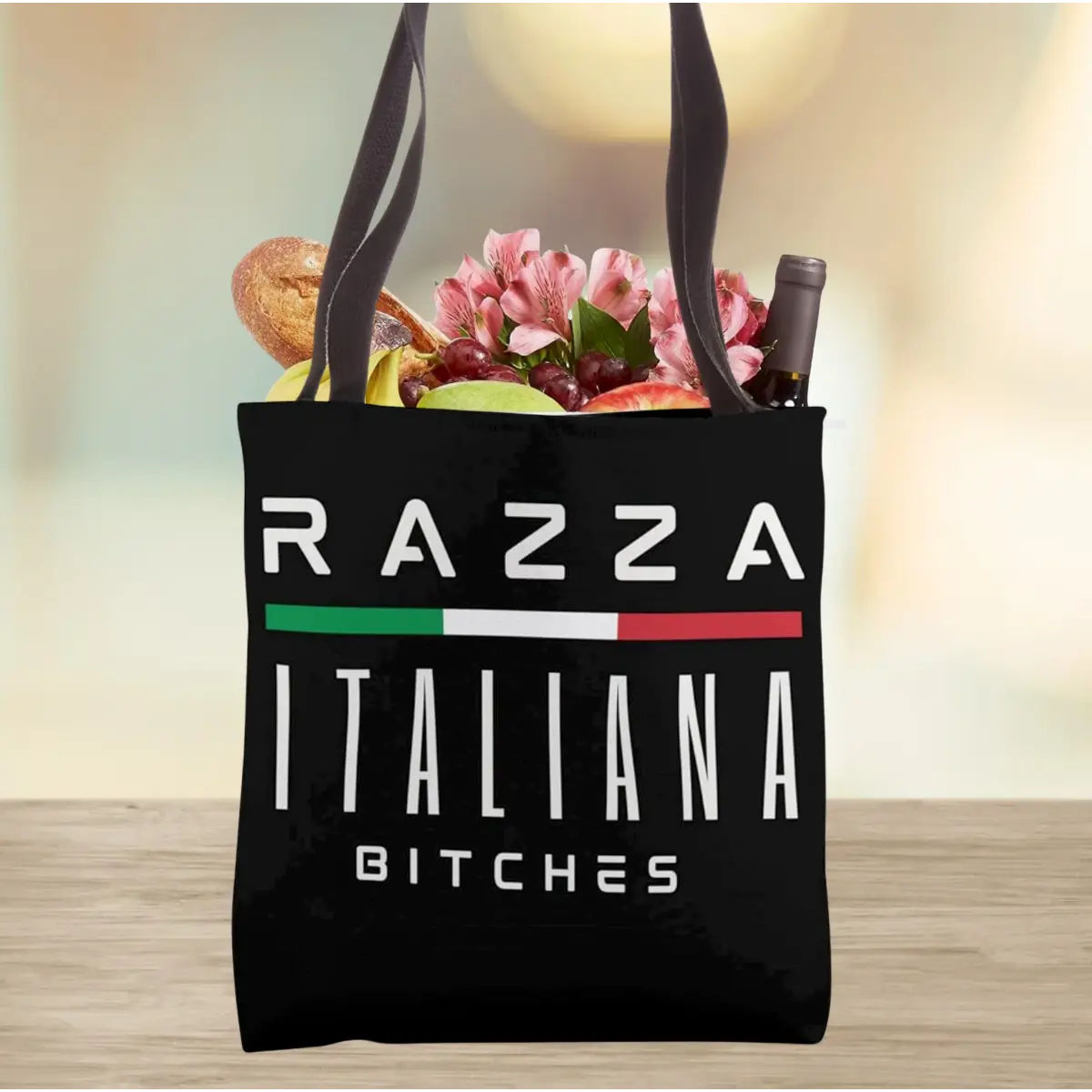 Black tote bag with 'Razza Italiana Bitches' bold text. Funny Italian heritage accessory, gift for her, reusable shopping bag, gym bag, beach bag, and edgy everyday carry for Italian attitude. 