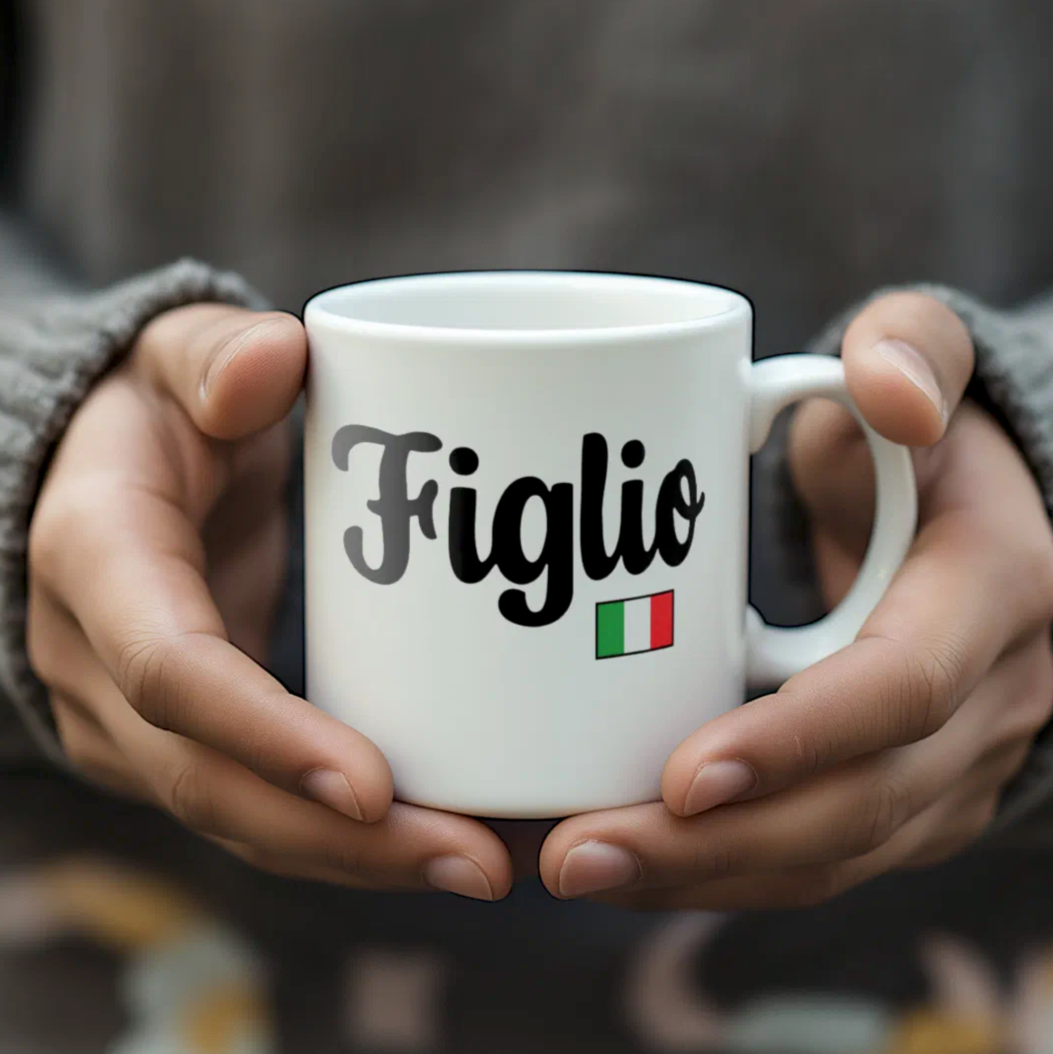 White mug with 'Figlio' and Italian flag held by hands against a blurred background