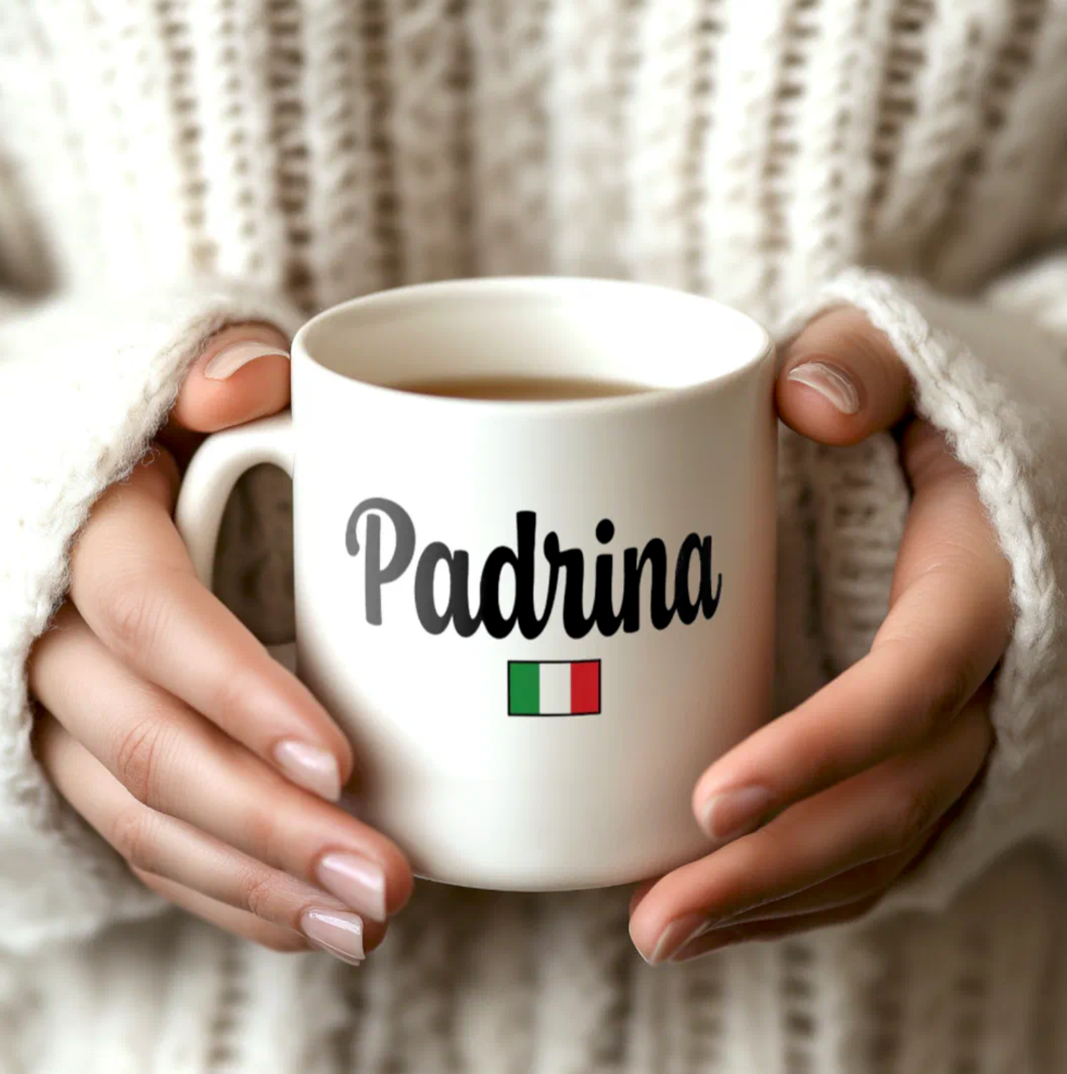 White mug with 'Padrina' text and Italian flag held by hands against a neutral background