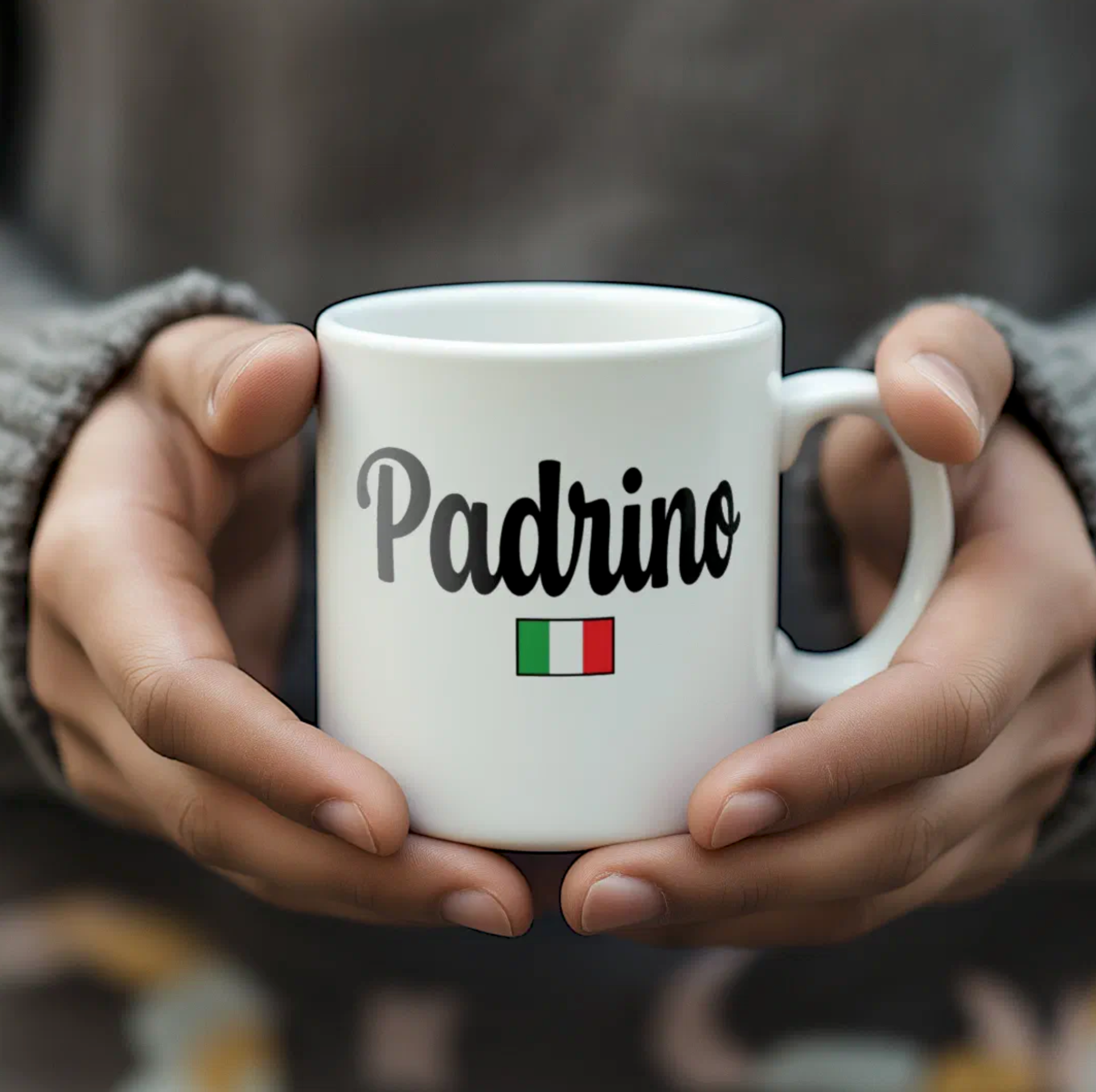 White mug with 'Padrino' text and Italian flag held by two hands against a blurred background