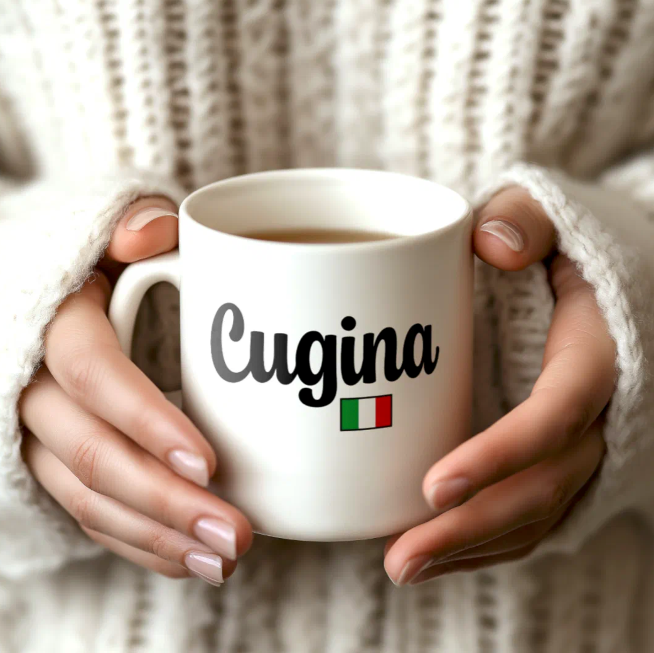 White mug with 'Cugina' text and Italian flag held by hands against a textured beige background