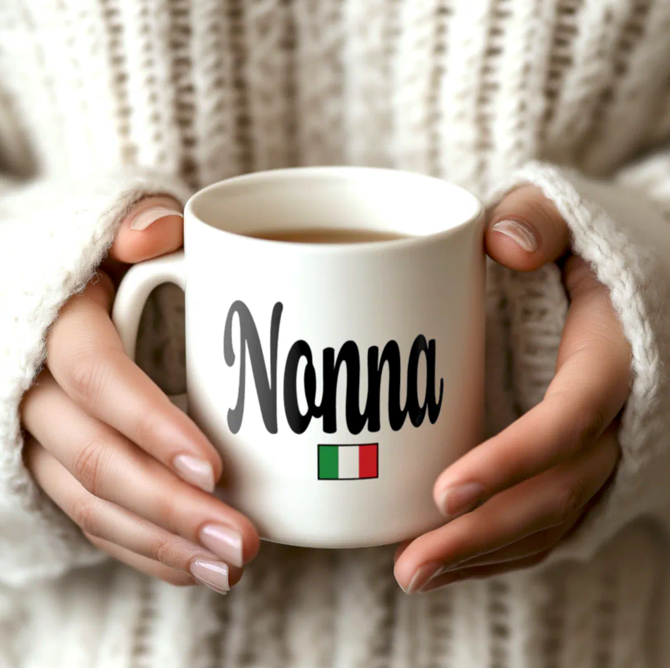 White mug with 'Nonna' and Italian flag held by hands against a neutral background