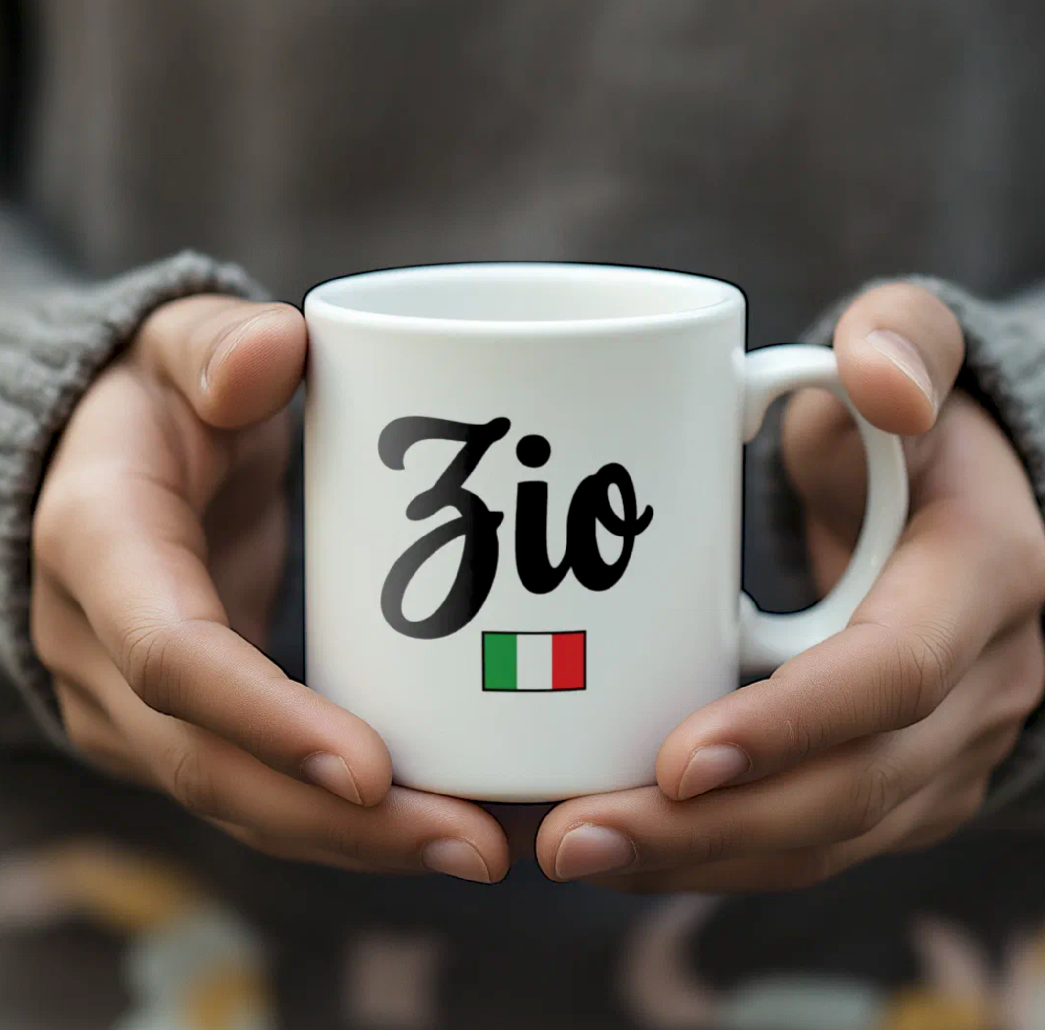 White mug with 'Zio' and Italian flag held by hands against a blurred background