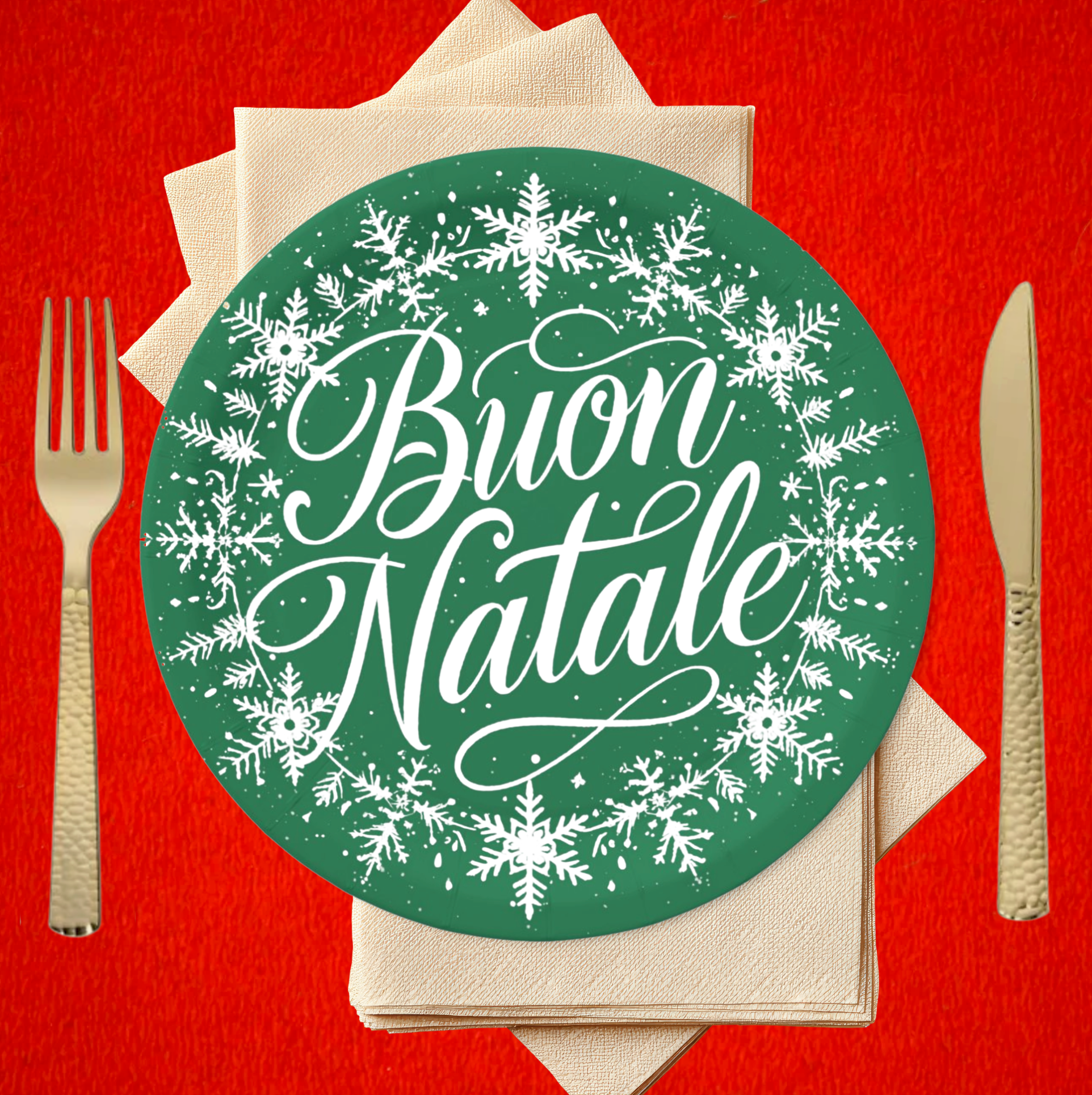 Green plate with 'Buon Natale' text and snowflakes on a red background with cutlery.