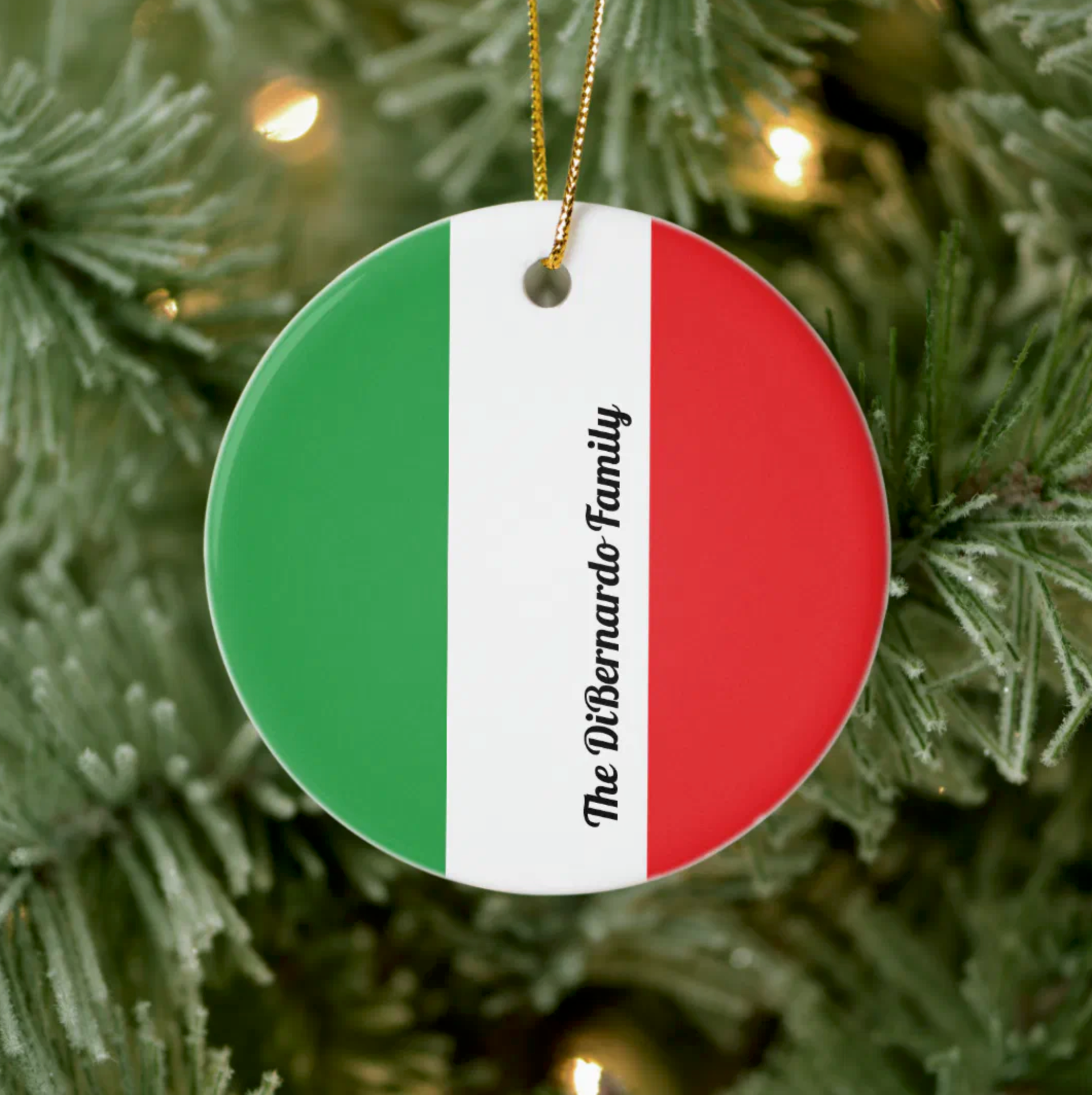 Round ornament with Italian flag design and 'DiBernardo Family' personalized text on a Christmas tree.
