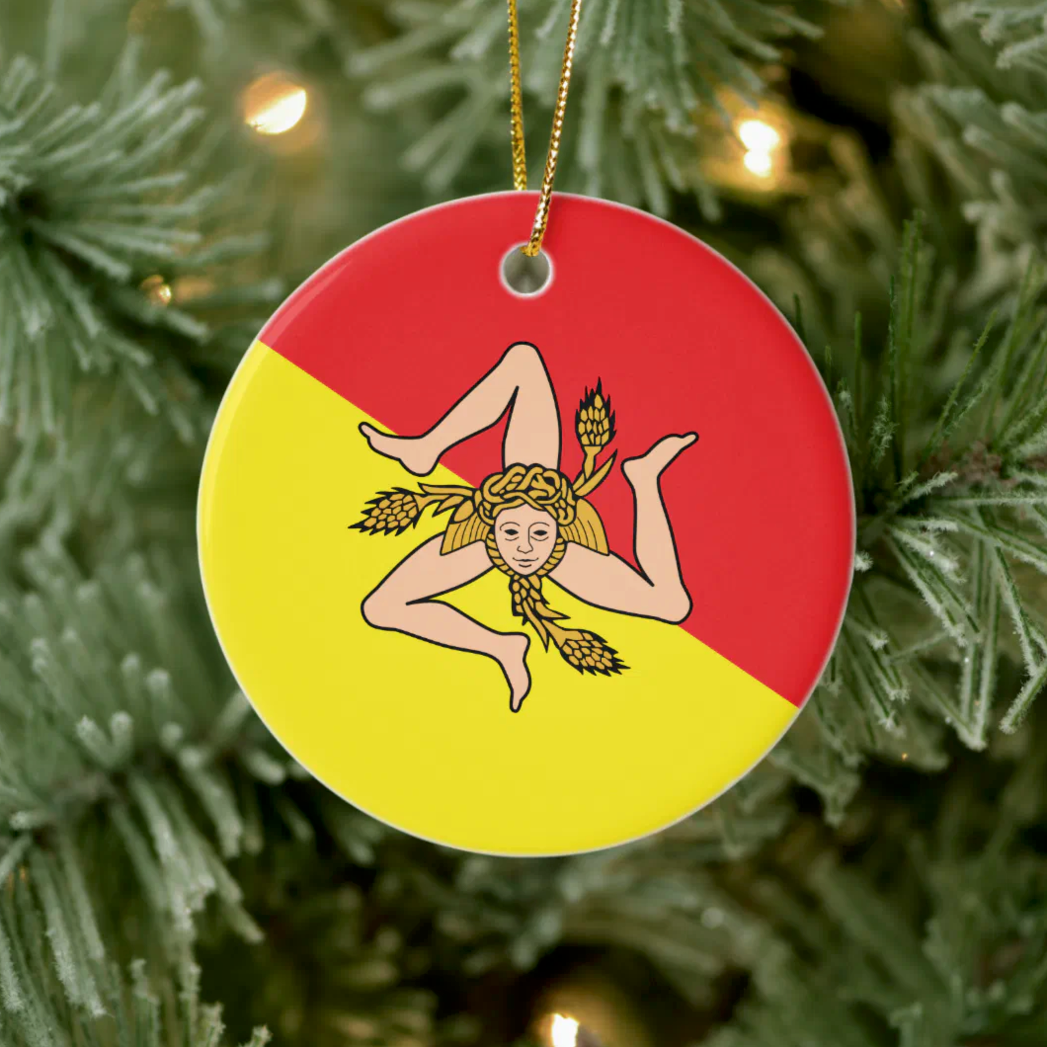 Decorative ornament with Sicily Flag on a red and yellow background, hanging on a Christmas tree.