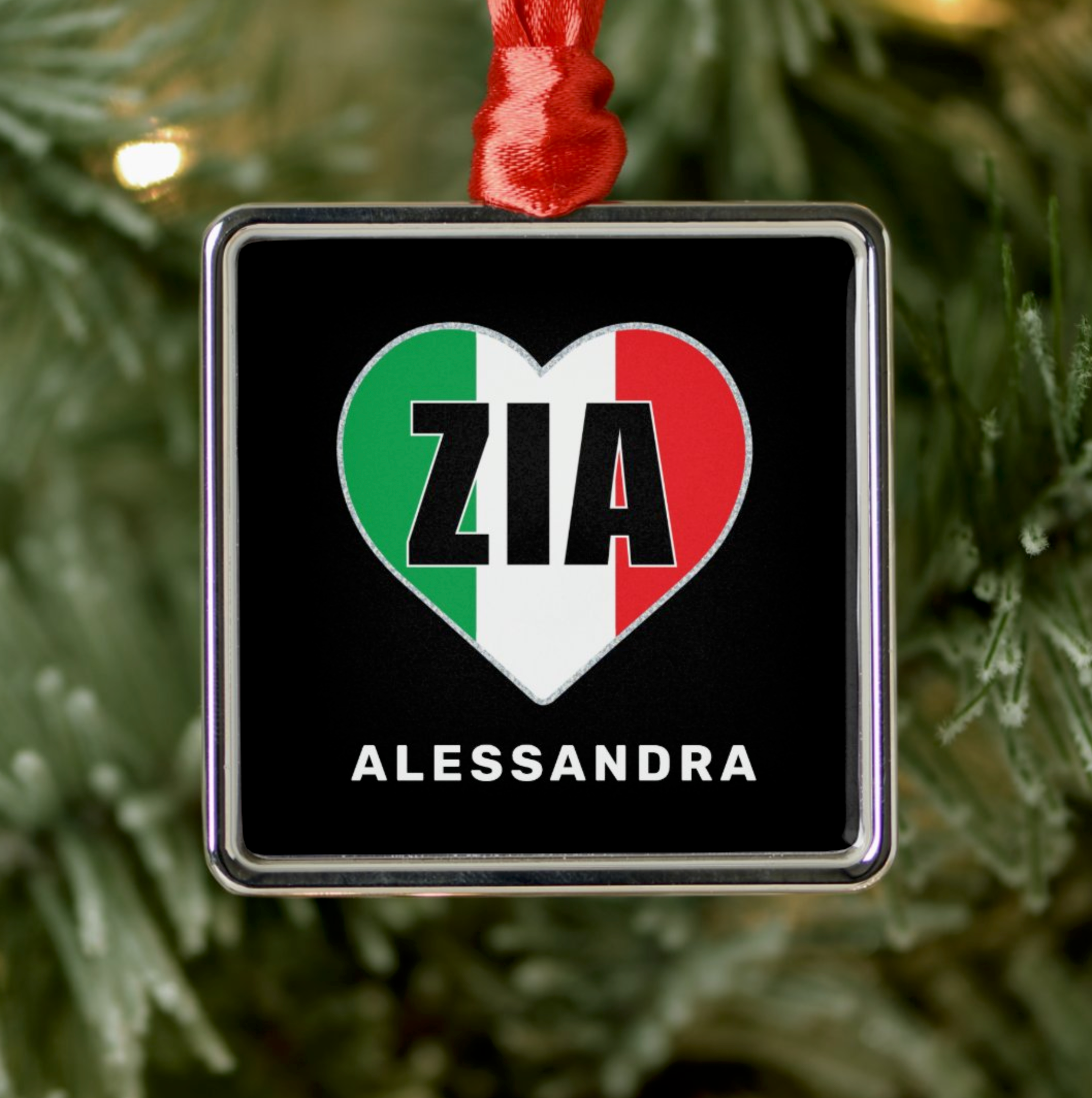 Decorative ornament with heart design featuring 'ZIA' and 'ALESSANDRA' personalized text, hanging on a Christmas tree.