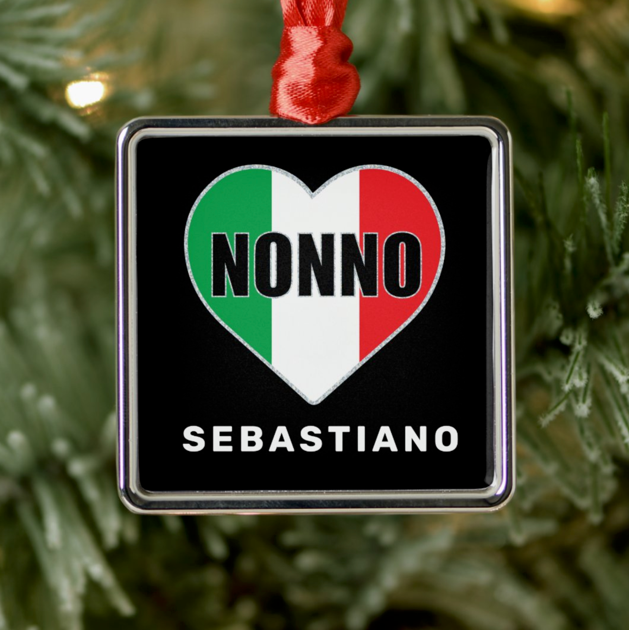 Decorative ornament with 'Nonno Sebastiano' personalized text on a heart-shaped Italian flag design, hanging on a Christmas tree.
