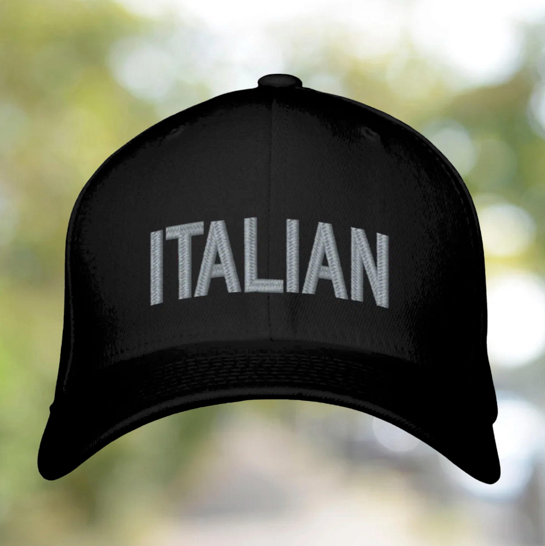 Black cap with 'ITALIAN' text on a blurred natural background