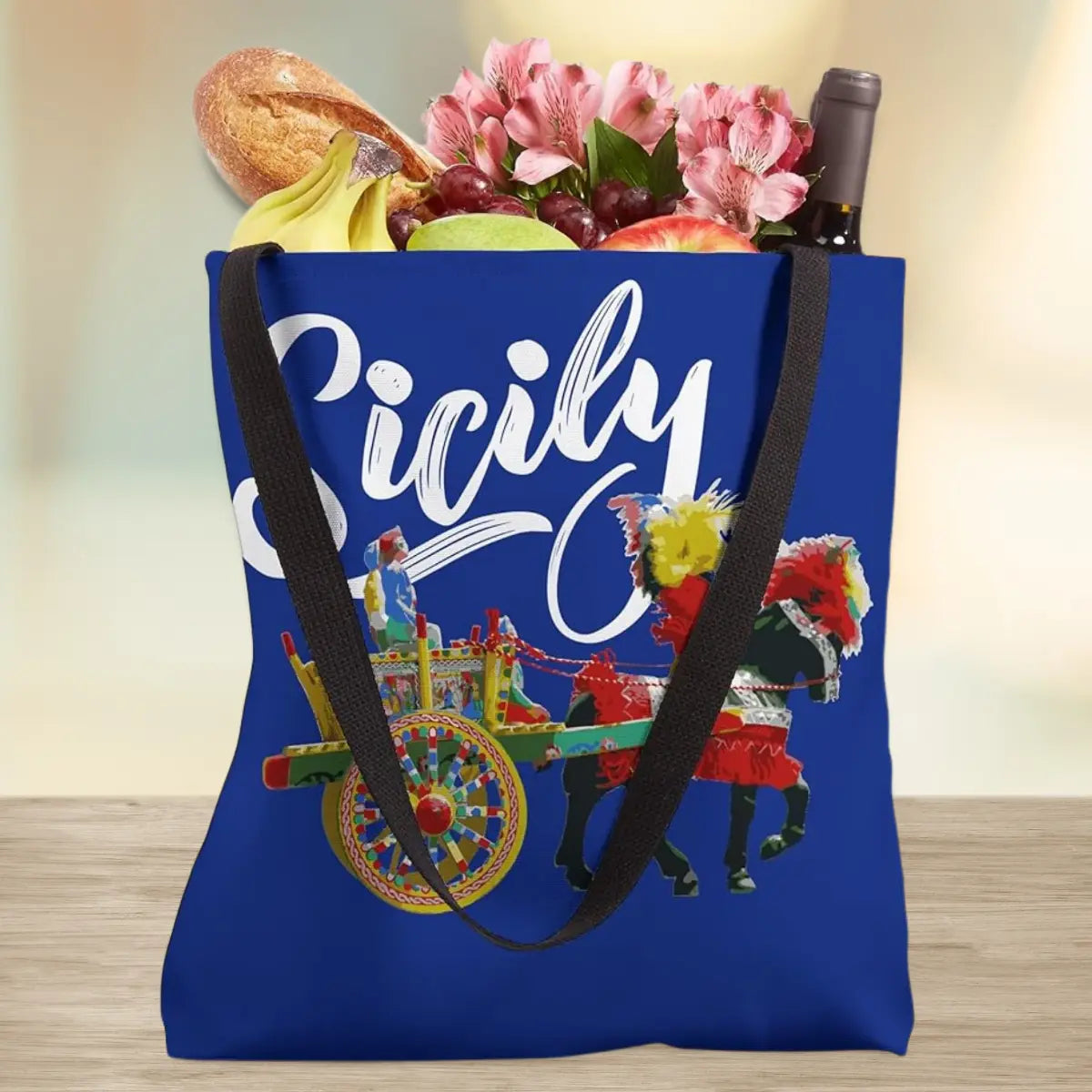 Royal blue tote bag with Sicily in white script and carretto siciliano (Sicilian cart). Sicilian heritage gift, Sicily pride tote, Sicilian tote bag, gift for Sicilian family, Trinacria tote, Sicilian American gift, Sicily travel bag, Sicilian cart design.
