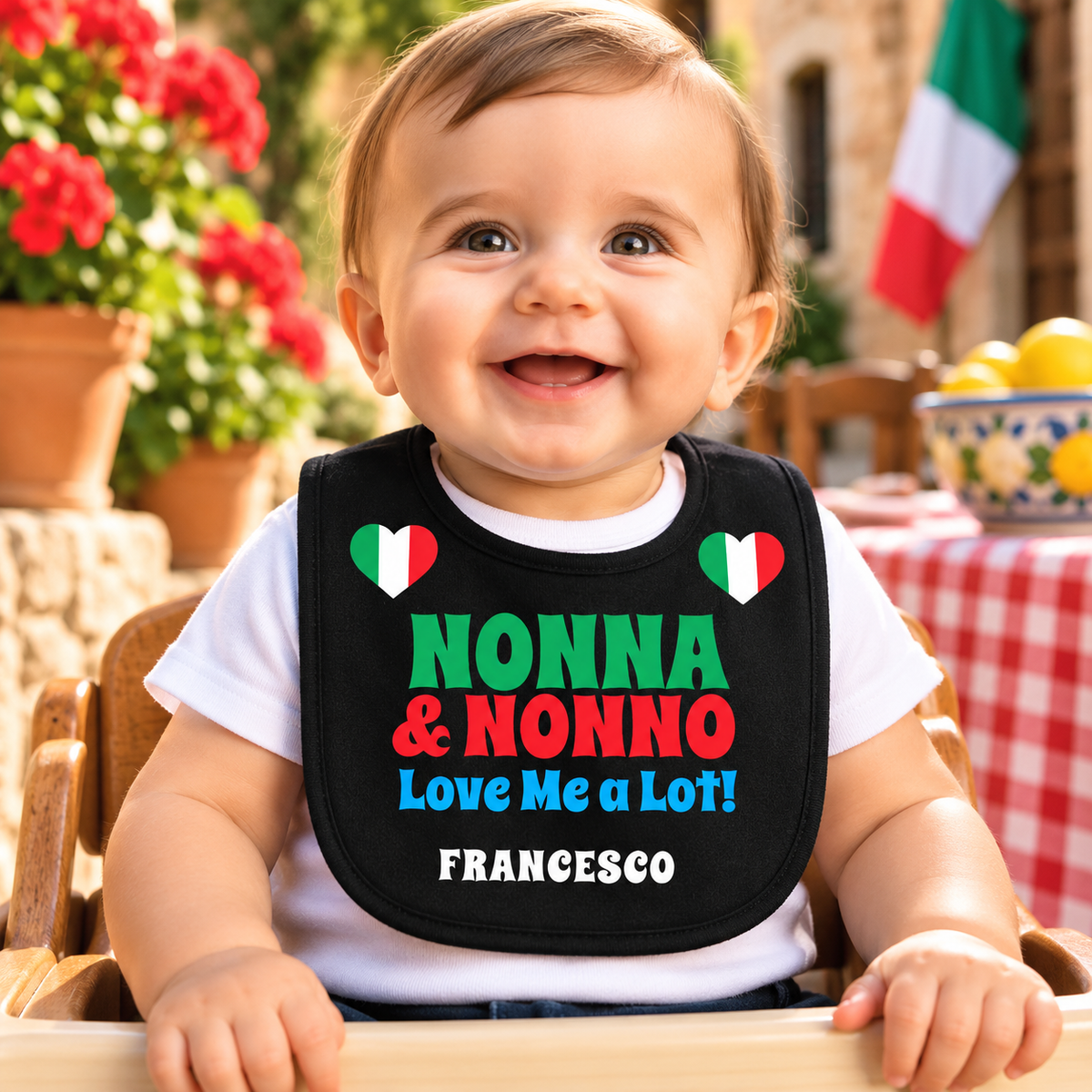 Smiling Italian baby wearing a personalized black “Nonna & Nonno Love Me a Lot!” bib with Italian flag hearts and the name Francesco. Cute Italian grandparent gift.