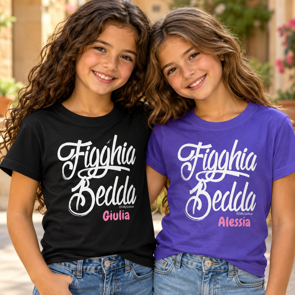 Two sisters wearing personalized black and purple “Figghia Bedda” Sicilian girls’ T-shirts, meaning “Beautiful Daughter,” with custom names in pink.