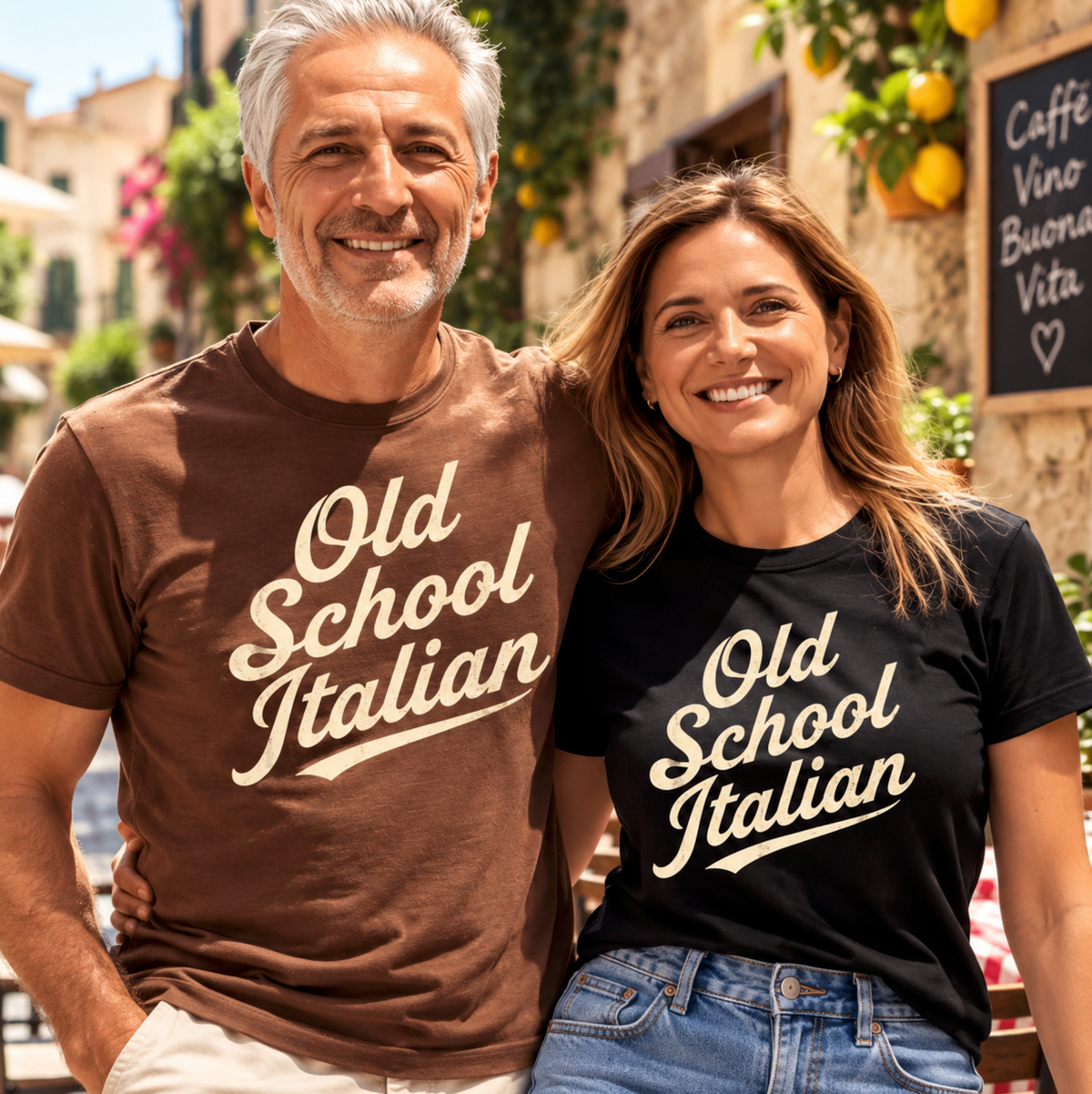 Couple wearing matching Old School Italian T-shirts in a sunny Italian village café setting.