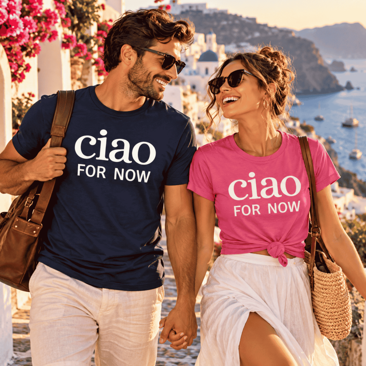 Newlywed couple wearing matching Ciao for Now honeymoon T-shirts in navy and pink while vacationing on the Mediterranean coast. A fun Italian-inspired wedding gift, bridal shower gift, or honeymoon outfit for couples.