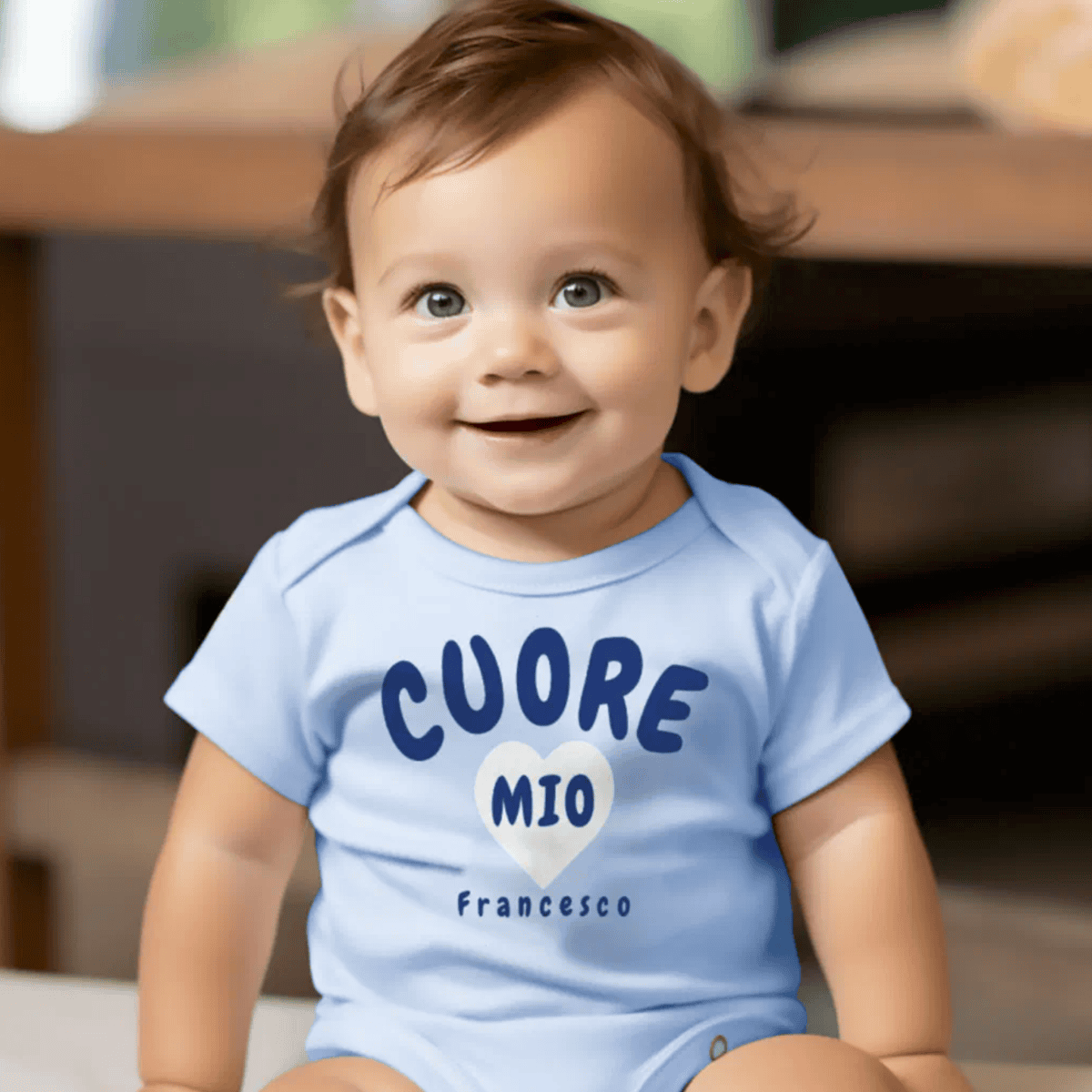Baby wearing a light blue onesie with 'CUORE MIO Francesco' printed on it - personalized Italian Sicilian heritage baby gift