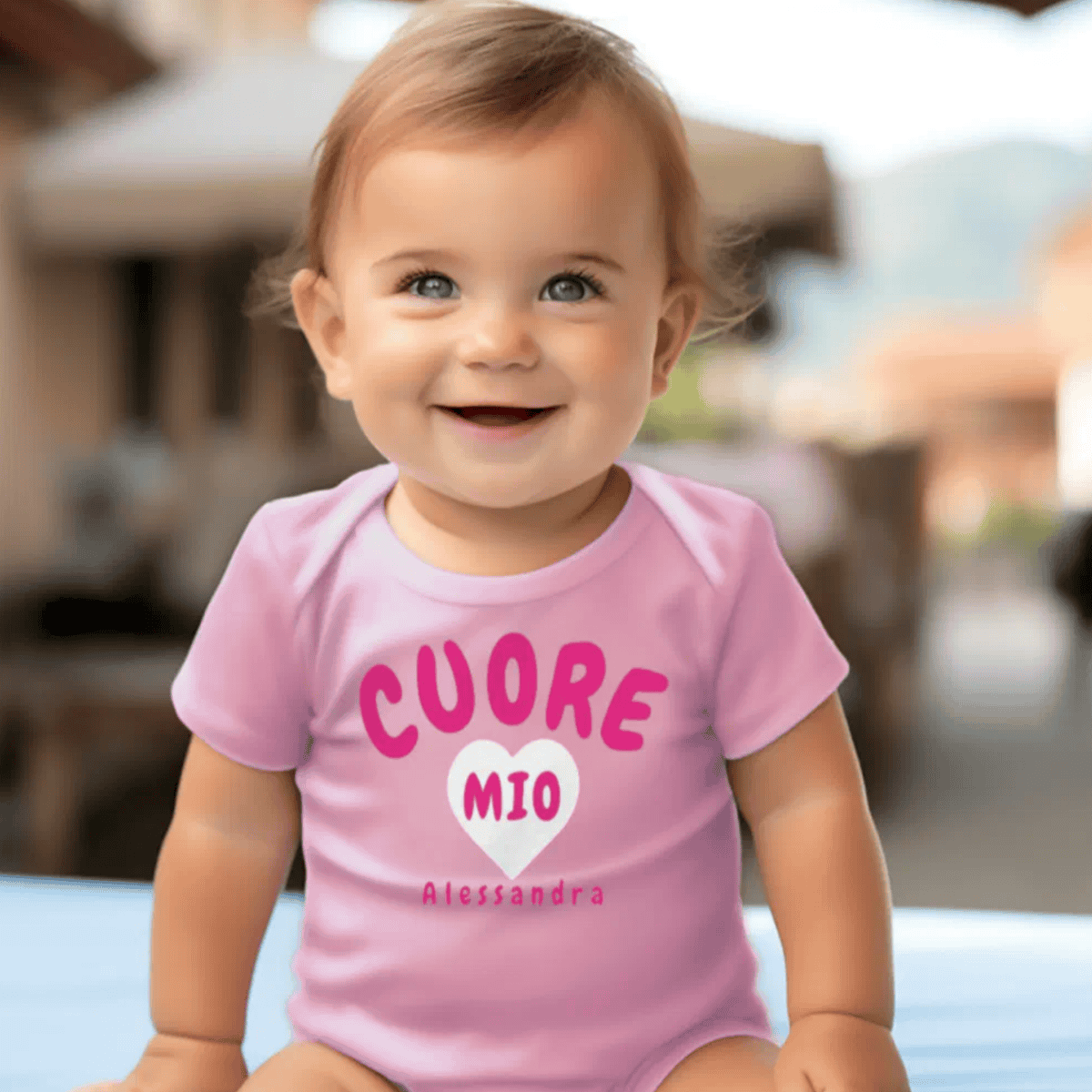 Baby wearing a pink onesie with 'CUORE MIO' text, Italian Sicilian heritage baby gift