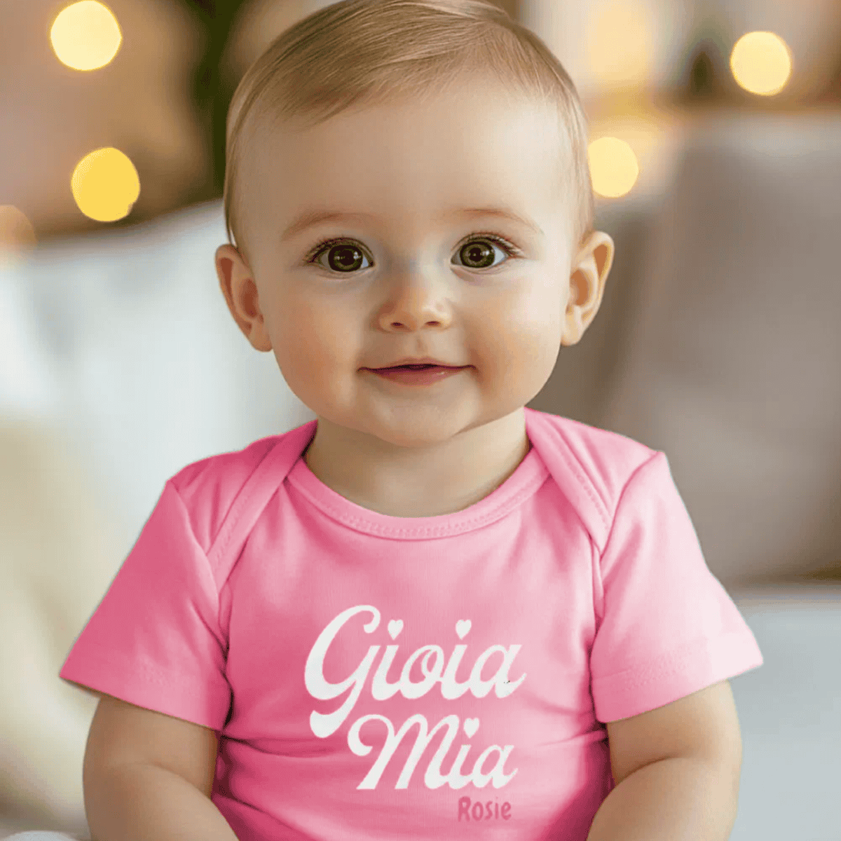 Baby wearing a pink bodysuit with 'Gioia Mia Rosie' text - personalized Italian heritage gift for baby shower