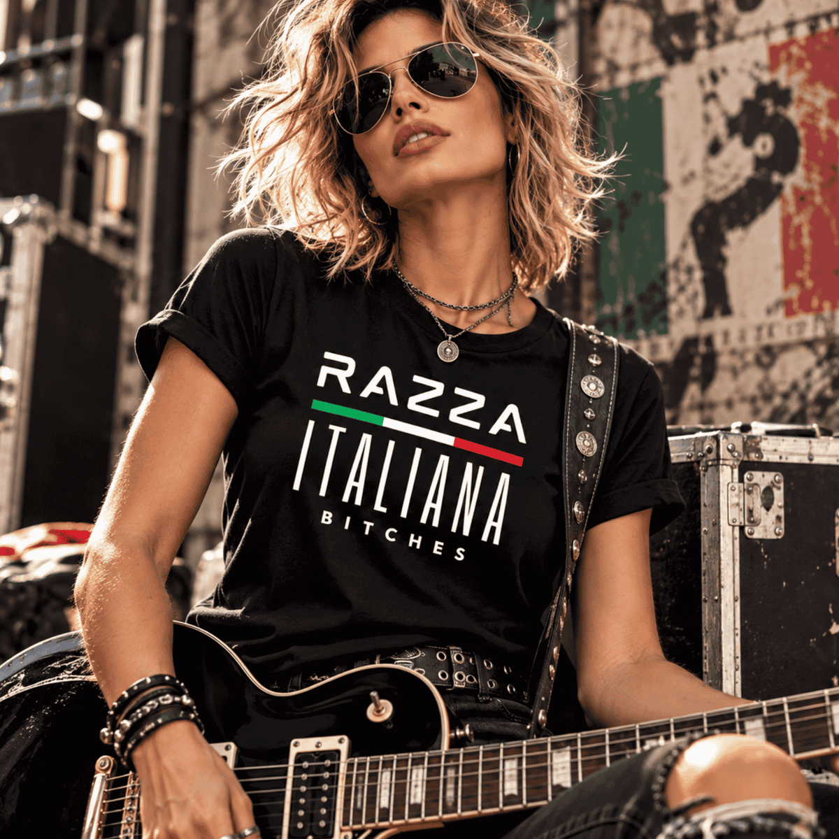 Razza Italiana Bitches black Italian graphic T-shirt worn by a rebellious female rock musician with electric guitar, Italian flag design, edgy Italian pride shirt and Italian American gift.