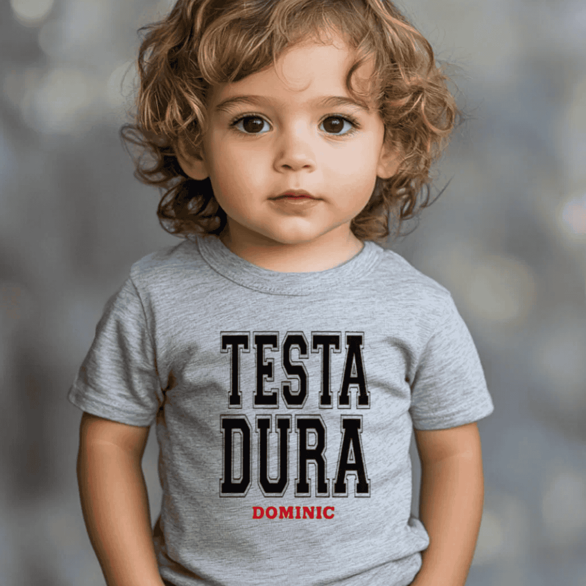Child wearing a gray t-shirt with 'TESTA DURA DOMINIC' (stubborn in Italian) - personalized heritage  toddler tee 